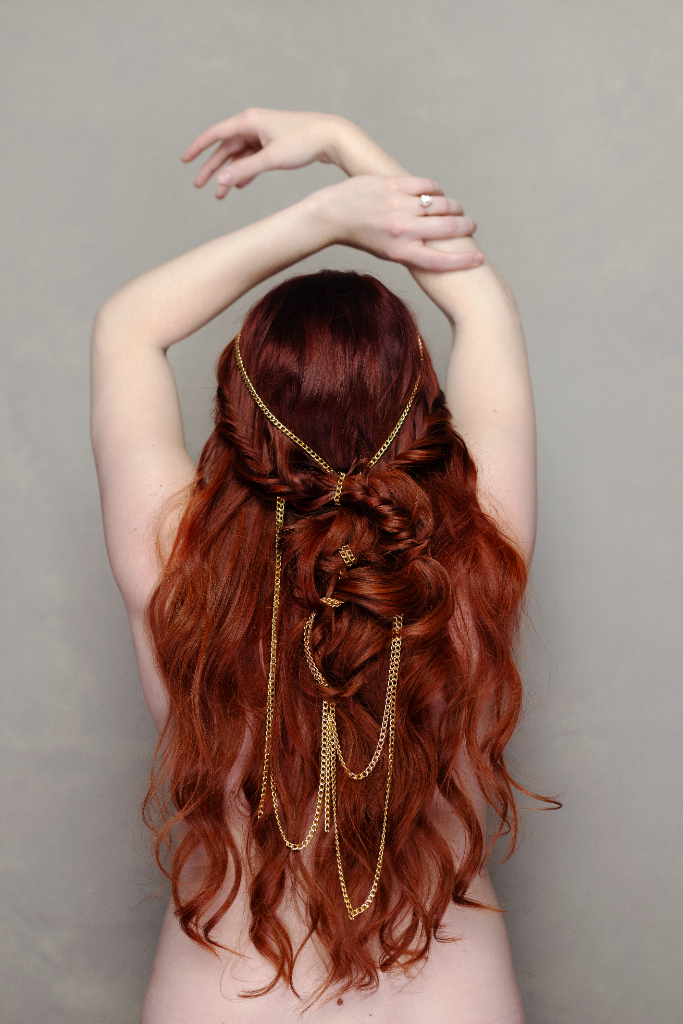 Model with stunning braided updo and gold chains, runway-ready Mixie Mane look