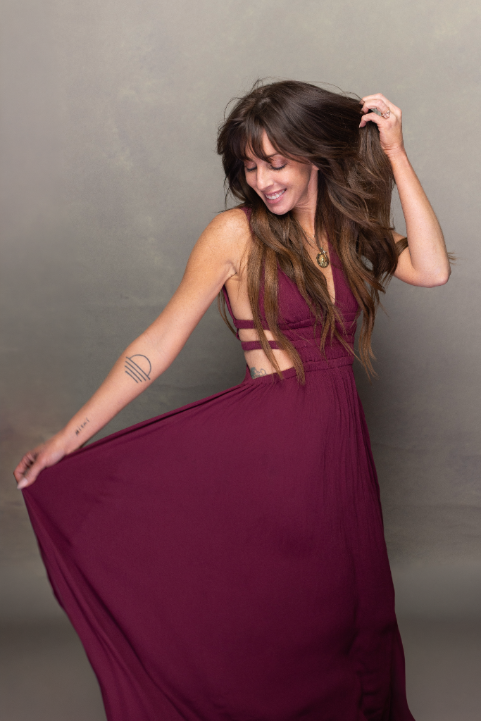 Michelle in elegant purple dress, sensory-friendly Mixie Mane extensions