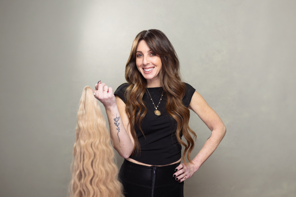 Michelle holding a Mixie Mane extension showing the length and quality